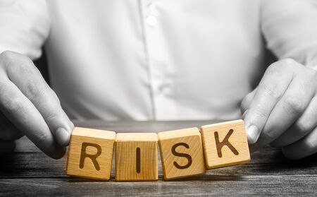 The man carelessly raises the word Risk. Caution and anticipation of possible problems and shocks....