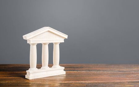 White building figurine with pillars in antique style. Concept of city administration, bank, university, court or library. Architectural monument in old town part . Banking, education, government.の写真素材