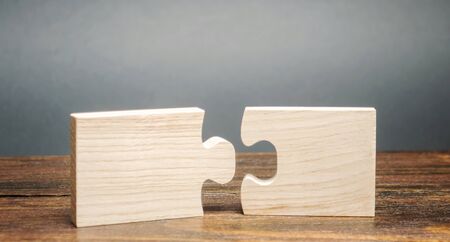 Wooden puzzles. Concept of success, business solutions. Strategy and goal achievement. Making the right decision. Connection and partnership.の写真素材