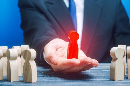Businessman presents a newly appointed chief leader. Promotion at work, appointment of a new overseer. Control and optimization of the company. Professional qualified employee. Example to followの写真素材