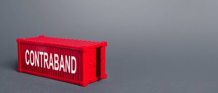 Red cargo shipping container with the word Contraband. Traffic of prohibited goods and products, bypassing customs, smuggling. Corruption, violation of the embargo, circumvention of sanctions. Importの写真素材