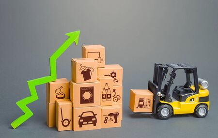 Forklift next to boxes and green up arrow. Logistics, transport infrastructure. Growth of online distribution of goods, increased delivery. E-commerce. High demand and sales. Economic recovery.の写真素材