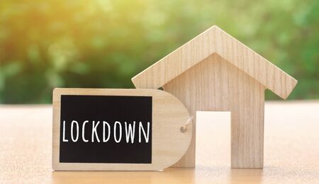 Wooden house and the inscription Lockdown. Coronavirus pandemic infection COVID-19. Isolation of people. Obstruction of the spread of the virus. Self-isolation. Confinement, quarantineの写真素材