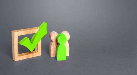 People are standing next to green check mark. Run for election. Voting on democratic election or referendum. Political campaign. Public poll. Legislative Initiative. Lobbying interests. Resolution.の写真素材