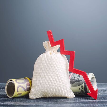 Big money bag and red arrow down. Economic difficulties. Capital flight, high risks. Costs expenses. Stagnation, declining business activity, falling wealth. Crisis, loss savings. Global recessionの写真素材