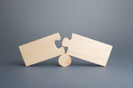 Two disassembled puzzles. Stop of work process and destruction of integrity due to obstacles or...
