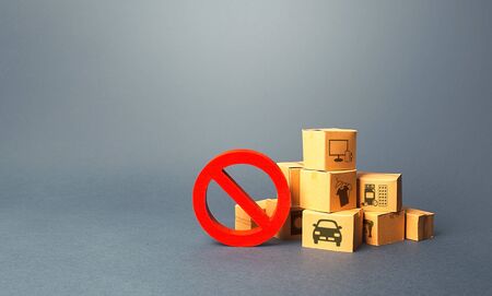 Boxes and red prohibition sign NO. Overproduction of goods, lack of demand. Sanctions and embargo. Shortage of products delivery. Transition of a trading business online. Market changes and adaptationの写真素材