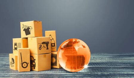 Orange glass earth globe and boxes. International world trade distribution. Delivery of goods,...
