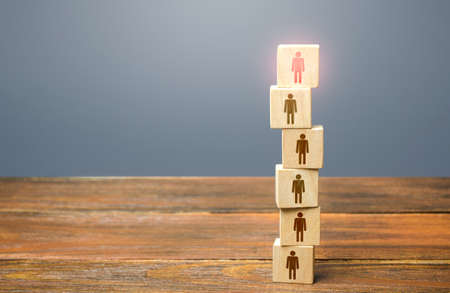 Red leader on top of a tower of people. Leadership skills. Teamwork, cooperation and collaboration....
