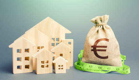 Residential houses and a euro money bag. Property real estate valuation. Buying and selling, fair price. City municipal budget. Calculation of expenses, construction and repair. Mortgage loanの写真素材