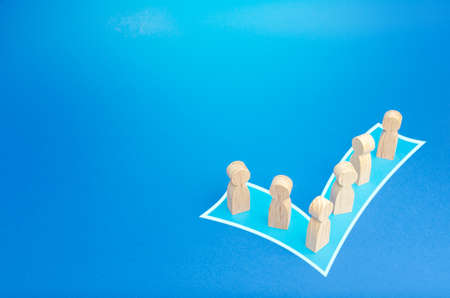 People stand in shape of a checkmark vote. Participate in democratic elections. Unification into a...