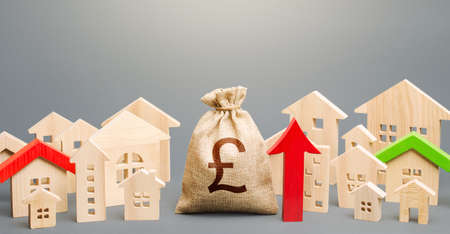 British pound sterling money bag and a city of house figures and red up arrow. Investments. Increase...