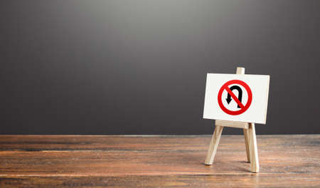 Easel with no turning back traffic sign. Go to the goal, don't stop. Assertiveness and striving, moving forward without retreating. Finish things. There is no way back. Obstinacy and irrevocabilityの写真素材