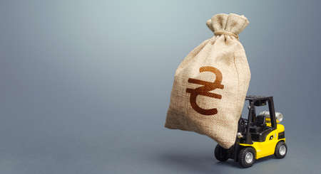 Forklift transports a Ukrainian hryvnia money bag. Financial assistance, business support....