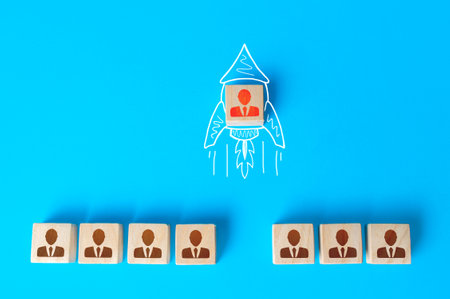 A human figurine flies out of a row of colleagues on a drawn doodle rocket. Promotion at work, appointment to team leader. Initiative and aspiration. Impressive success, a business career accelerator.の写真素材