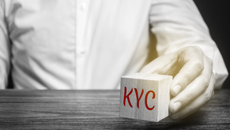 Wooden block with the word KYC - Know Your Customer / Client. Verify the identity, suitability and risks involved with maintaining a business relationship. Anti-bribery compliantの写真素材