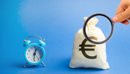 Blue alarm clock and a money bag. Loan, credit, mortgage concept. Deposit, money investment....