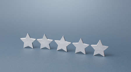 Five gray stars. Rating evaluation concept. Service quality. Buyer feedback. Popularity rating of a restaurant, hotel or mobile software applications apps. High satisfaction. Good reputation status.の写真素材