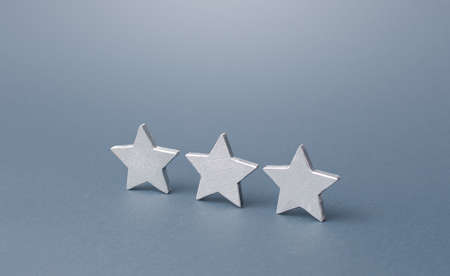 Three gray stars. Rating evaluation concept. Service quality. Buyer feedback. High satisfaction....