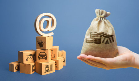 Money bag, stack of boxes and email internet symbol. Online Internet distribution of goods. E-commerce. Network marketing advertising. Remote non-contact trade services. Economic reorientationの写真素材