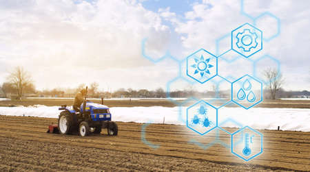 Farmer on a tractor with milling machine loosens, grinds and mixes soil. Agricultural startups,...
