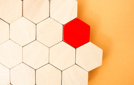 One red hexagon stands out from the rest. Leadership and victory concept. Dissimilarity and dissent. Uniqueness initiative. Superfluous, unsuitable. Going beyond. Untypical Conceptの写真素材