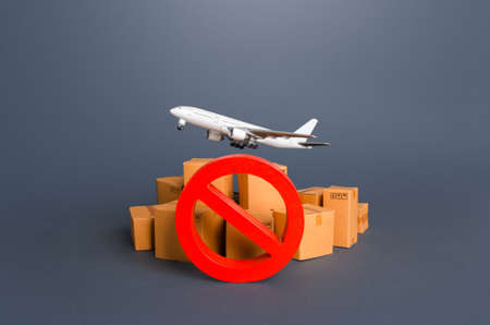 Cargo plane, boxes and red prohibition symbol NO. Embargo, a ban on commercial aircraft. Sanctions. Restrictions on export of strategically important goods and resources. Lack of transport capacityの写真素材