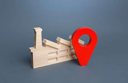 Industrial plant and red location pin. ?oncept of the location of production facilities. Logistics, access to infrastructure. Trend of protectionism or globalization. Supply and export of products.の写真素材