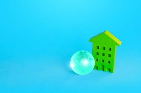 Green multi-storey residential building and blue earth globe. Green technologies. Environmentally...