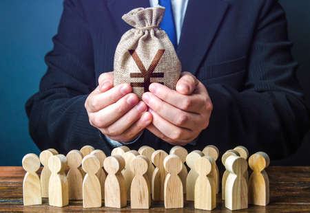 Businessman holds out a chinese yuan or japanese yen money bag to the crowd. Financial support. Tax collection. Compensation payments. Share profit. Providing money, paying salaries and grants.の写真素材