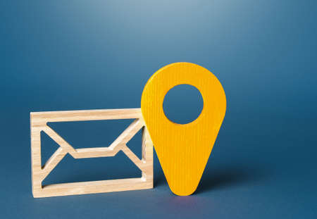 Envelope and yellow location symbol. Delivery of correspondence and documents. Communication, e-mail newsletter. security and confidentiality. Sending price lists and special offers for customers.の写真素材