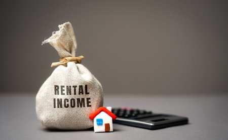 rental income concept. The concept of profit from the rental of real estate, apartments or houses. Landlord income from housing. Money bag, miniature house and calculatorの写真素材