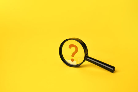 Magnifying glass and question mark. FAQ. Curiosity, inquiry, uncertainty. Search for answers, clarity, and understanding. Quest for knowledge or solutions. Solving mysteries, uncovering hidden truths.の写真素材