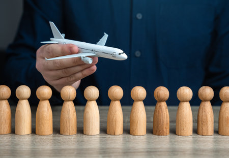 A man holds a plane in his hand over figures of people. Passenger transportation. Business and...