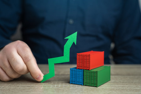 Shipping containers and a green arrow up. Increased transportation volumes and income growth....