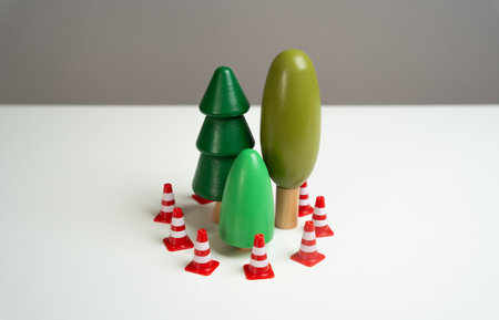 A forest surrounded by traffic cones. Preserving the environment and forest protection. Environmentally friendly and natural. Afforestation planting, combat climate changeの写真素材