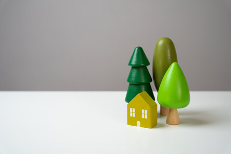 House and forest, figures. Environmental friendliness and autonomy of housing. High energy saving technologies, in harmony with nature.の写真素材