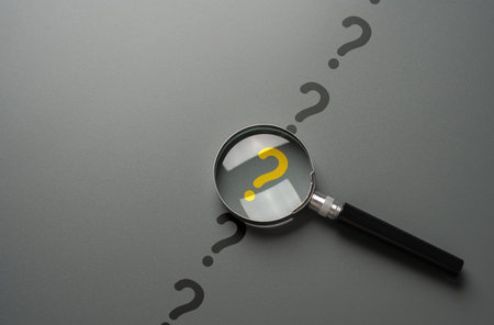 Magnifying glass and yellow question mark. FAQ. Solving mysteries, uncovering hidden truths. Curiosity, inquiry, uncertainty. Search for answers, clarity understanding. Quest for knowledge solutionsの写真素材