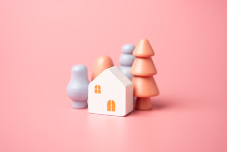 House and trees, figures. Garden work, landscape design. Figurine. Mortgage and loan. Affordable housing. Buying a nice house.の写真素材