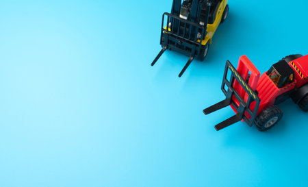 Forklifts and space for text on a blue background. Efficient logistics and distribution systems. Management of warehousing and shipping of orders and goods.の写真素材