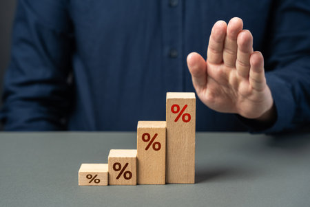 Businessman stops interest growth. Stop rising inflation or debt. High taxes, financial burden on business. Suffers losses. Tax burden. Refinancing, restructuring of loans. Falling demand, bankruptcy.の写真素材