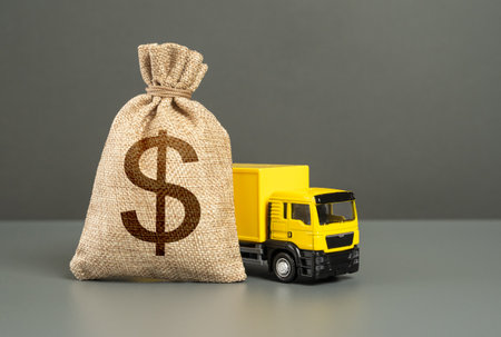 Cargo delivery truck and dollar money bag. Loan or deposit. Financial aid, investments and...