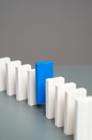 The blue domino stands out from the chain. Stand out. Initiative and talent. Job search and hiring....