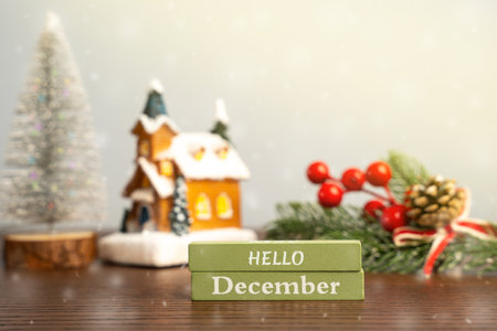 Hello December blocks against the background of a Christmas tree and a house with snow. Concept of the beginning of a new winter seasonの写真素材
