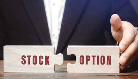 Stock option concept. Investor right to buy or sell a stock at an agreed-upon price and date. Business and finance. Puzzles in the hands of a businessmanの写真素材
