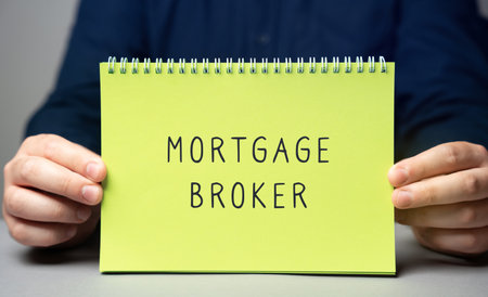 Mortgage broker concept. A licensed intermediary who connects borrowers with lenders by offering expert advice and assistance tailored to the borrower's financial needs. Note in male handsの写真素材