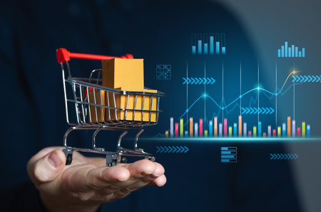 Businessman holding shopping cart with boxes and sales charts. Retail concept and sales statistics. Performance analysis, market trends. Consumer experiences and enhance business efficiency.の写真素材