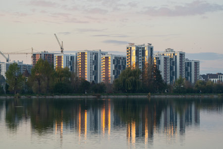 Beautiful view of the city lake with Multi-storey buildings with apartments. New residential complex and new buildings. City district. Real estate concept. Ivano-Frankivsk, Ukraine - October 28, 2024.の写真素材