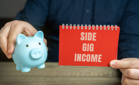 Side gig income refers to earnings generated from work or activities done in addition to a person's primary job. Notebook and piggy bank in male hands. business and finance conceptの写真素材