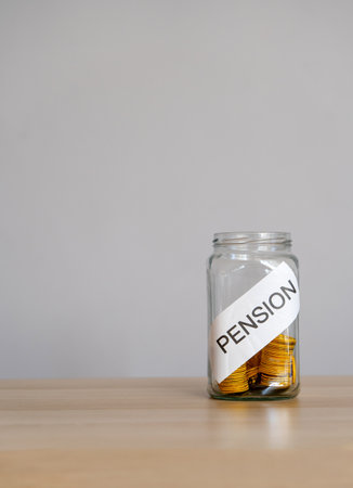 Bank of coins and the inscription Pension. Saving money and retirement concept. Accumulation of pension contributions. Business and finance.の写真素材
